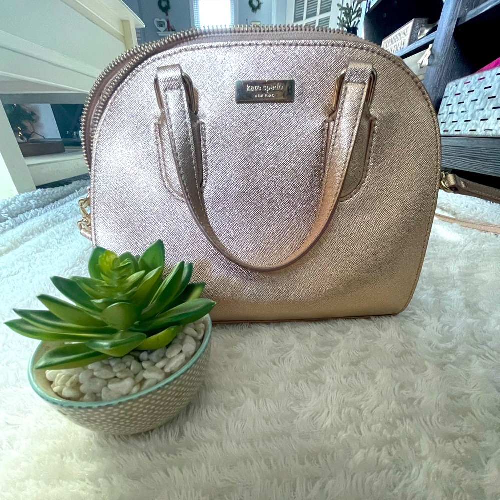 Rose gold Kate Spade purse with removable strap.